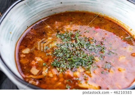 Vegetable soup with red beans, borscht, tomato soup, soup kharcho in a white plate on a black 46210383
