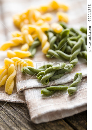 Uncooked spinach gemelli pasta. Uncooked spinach gemelli pasta. 46211228