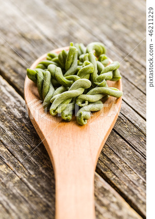 Uncooked spinach gemelli pasta. Uncooked spinach gemelli pasta. 46211229