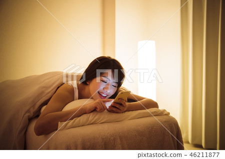 Woman sleep smart phone bedtime young woman cute lifestyle 46211877
