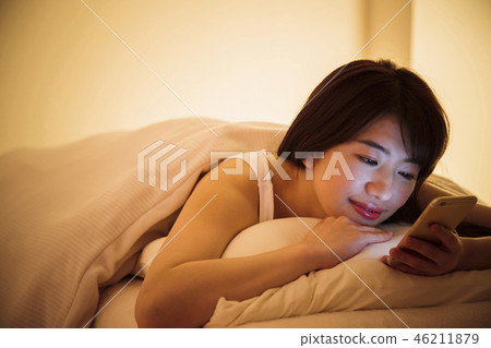 Woman sleep smart phone bedtime young woman cute lifestyle 46211879