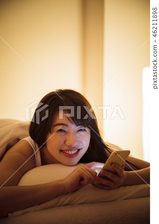 Woman sleep smart phone bedtime young woman cute lifestyle 46211898