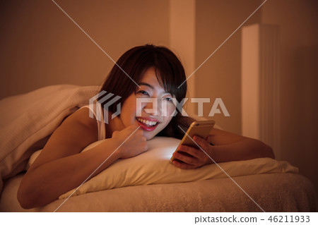 Woman sleep smart phone bedtime young woman cute lifestyle 46211933