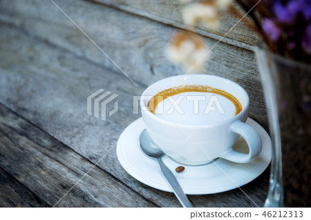 Coffee cup and vase on table. Coffee cup and vase on table. 46212313