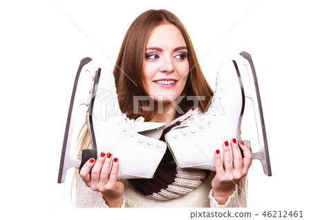 Smiling woman with ice skates Smiling woman with ice skates 46212461