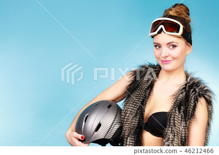Woman seductive girl in ski googles holds helmet Woman seductive girl in ski googles holds helmet 46212466