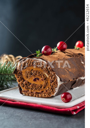 Buche de Noel. Traditional Christmas dessert, Christmas yule log cake with chocolate cream Buche de Noel. Traditional Christmas dessert, Christmas yule log cake with chocolate cream 46212654