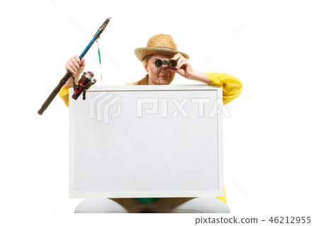 Happy woman with fishing rod holding board Happy woman with fishing rod holding board 46212955