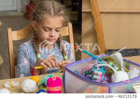 Girl crochets in a classroom at school 46213179