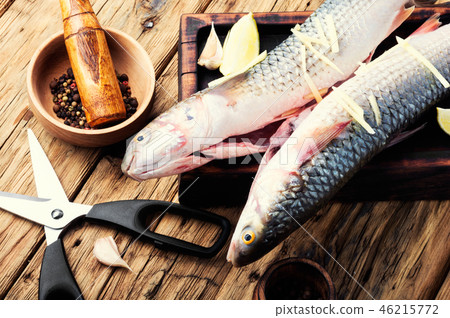 Whole raw spiced fish 46215772