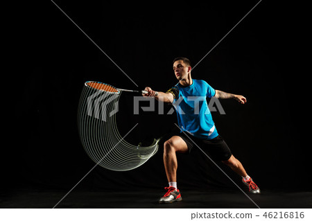 Young male badminton player over balck background 46216816