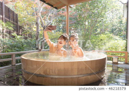 Young woman, girl trip, hot spring, open-air bath, smartphone Young woman, girl trip, hot spring, open-air bath, smartphone 46218379