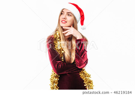 Beautiful girl in the hat of Santa thoughtfully Beautiful girl in the hat of Santa thoughtfully 46219184