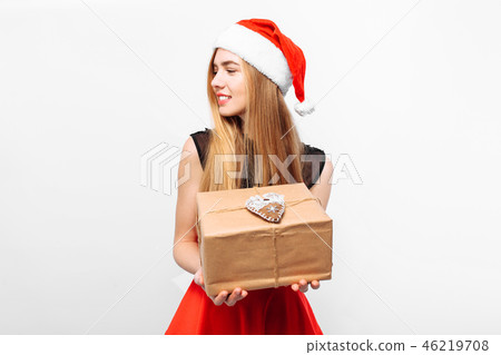 Happy young woman in santa hat and dress Happy young woman in santa hat and dress 46219708