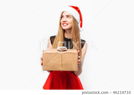 Happy young woman in santa hat and dress Happy young woman in santa hat and dress 46219710