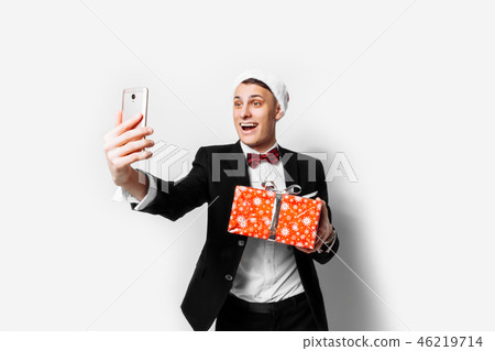 Shocked guy in a suit and a santa hat Shocked guy in a suit and a santa hat 46219714