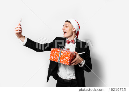 Shocked guy in a suit and a santa hat Shocked guy in a suit and a santa hat 46219715