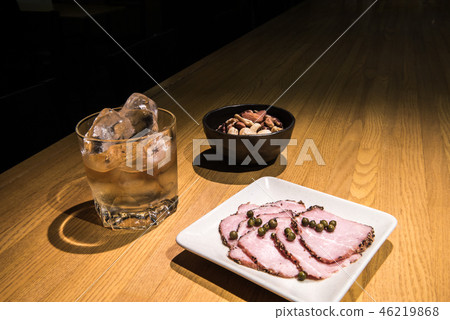 Whiskey rock in a bar with green pepper and mixed nuts and pepper ham 46219868