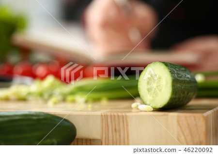 Cook holds knife in hand and cuts on Cook holds knife in hand and cuts on 46220092
