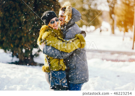 happy couple walking through the park on a sunny winter day happy couple walking through the park on a sunny winter day 46223254