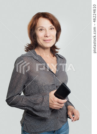 Mid adult woman using cell phone 46224610
