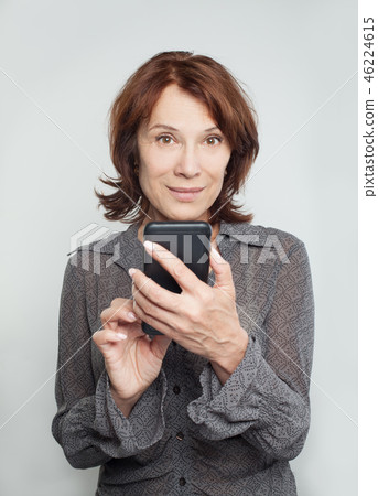 Smiling mature woman with cell phone 46224615