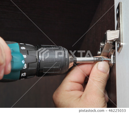 carpenter installs door hinges wardrobe 46225033