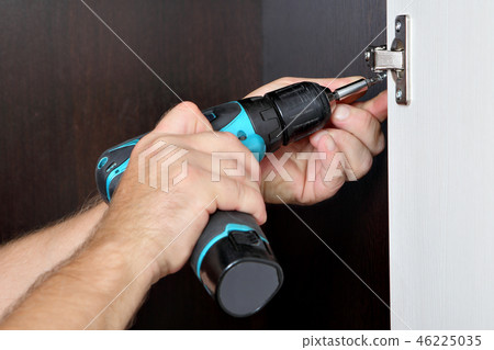 assembler is screwing cordless screwdriver assembler is screwing cordless screwdriver 46225035