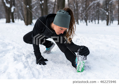 Female athlete exercising in park in winter 46225946