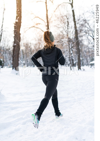 Female athlete jogging in park in winter 46225949