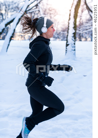 Female athlete jogging in park in winter 46225951