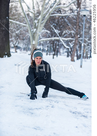 Female athlete exercising in park in winter 46225956
