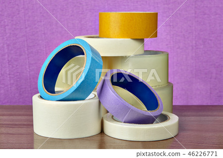 Pile of sticky tape lies on table, on purple  46226771