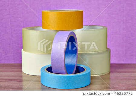 Pile of adhesive tape lies on table, on purple 46226772