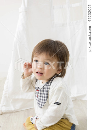 Toddler boy playing with indoor tent Toddler boy playing with indoor tent 46232095