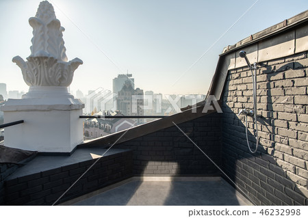 Cozy small terrace with brick walls on sunny cityscape background Cozy small terrace with brick walls on sunny cityscape background 46232998