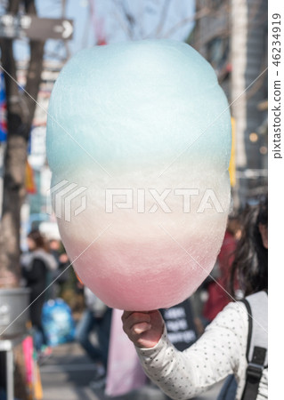 Cotton candy in kid hand, sugar cloud colorful Cotton candy in kid hand, sugar cloud colorful 46234919