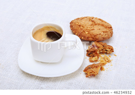 Classic espresso in white cup with cake and chocolate on white background. 46234932