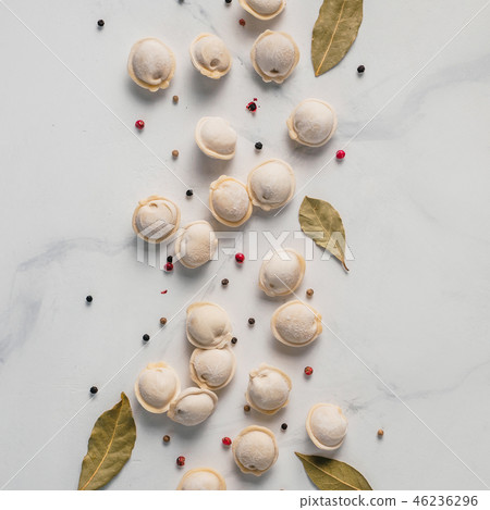 Beautiful scattered raw pelmeni on marble background Beautiful scattered raw pelmeni on marble background 46236296