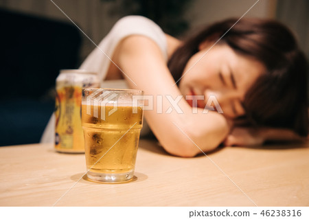 Drunk young Japanese woman drinking alcohol Drunk young Japanese woman drinking alcohol 46238316