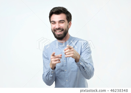 Portrait of a young man pointing his finger at you 46238348