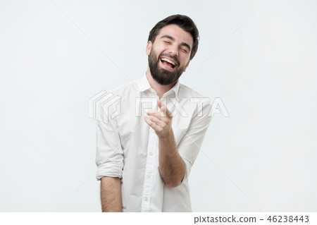 Portrait of a young man pointing his finger at you 46238443
