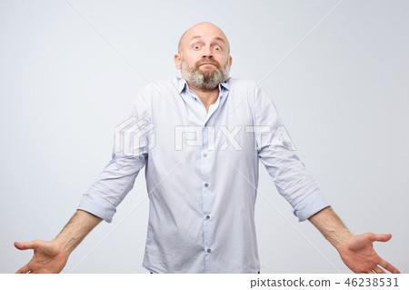 Confused mature bearded man shrugging shoulders 46238531