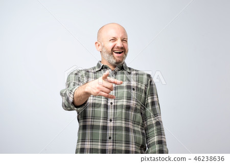 Mature man pointing finger and toothy smile. Mature man pointing finger and toothy smile. 46238636