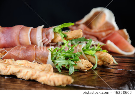 Grissini with prosciutto and arugula Grissini with prosciutto and arugula 46238663