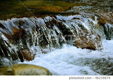Water surface with ripples and sunrays reflections Water surface with ripples and sunrays reflections 46239874