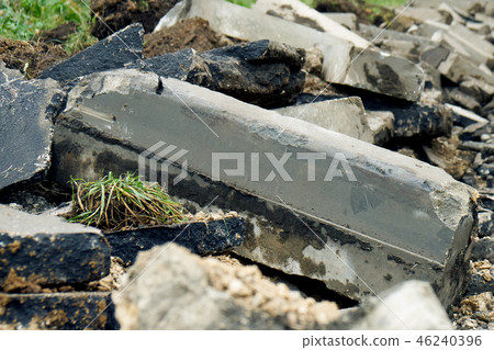 Broken freshly dug up old curbstones with pieces of an asphalt and earth lying on the road in Moscow Broken freshly dug up old curbstones with pieces of an asphalt and earth lying on the road in Moscow 46240396