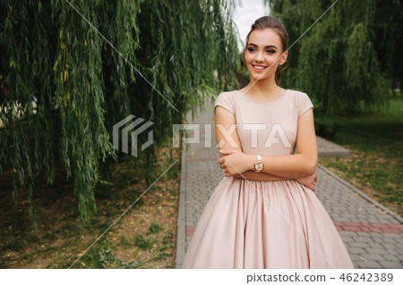 Young stylish model poses to photographer outside Young stylish model poses to photographer outside 46242389