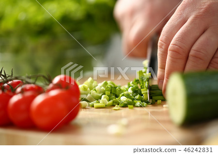 Cook holds knife in hand and cuts on 46242831