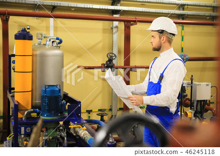Industrial worker with scheme analyzing oil pump Industrial worker with scheme analyzing oil pump 46245118